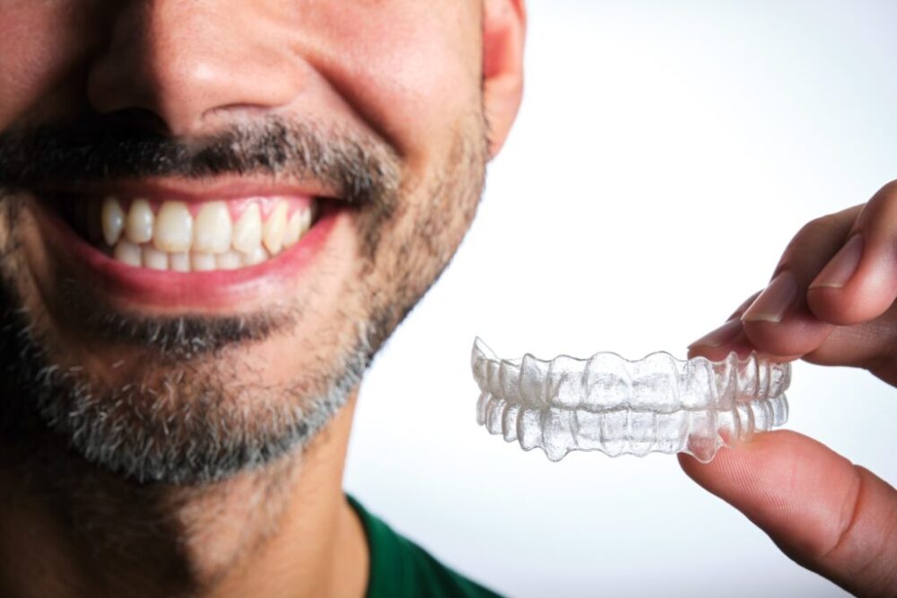 man with transparent dental retainer